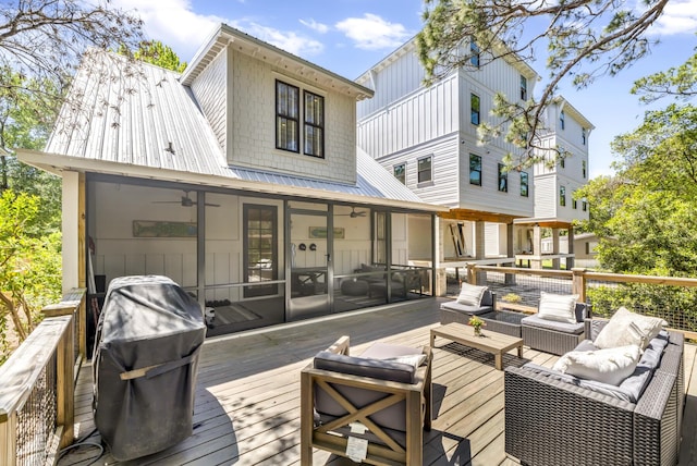 wooden terrace featuring a sunroom and an outdoor living space