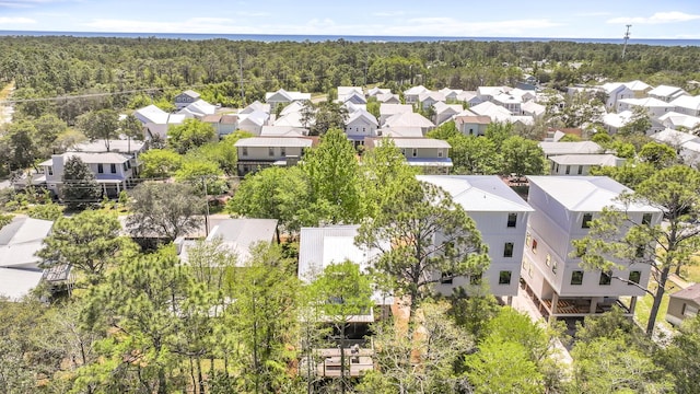 drone / aerial view featuring a residential view and a view of trees