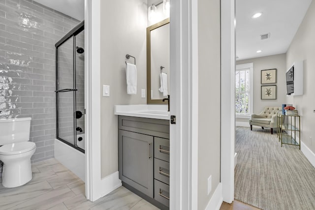 bathroom with toilet, recessed lighting, shower / bath combination with glass door, visible vents, and vanity