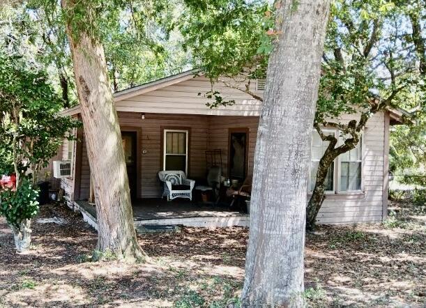 back of house featuring a porch