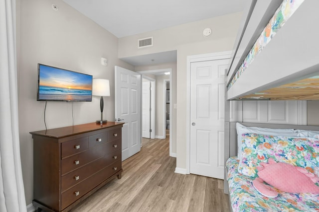 bedroom with light wood finished floors, baseboards, and visible vents