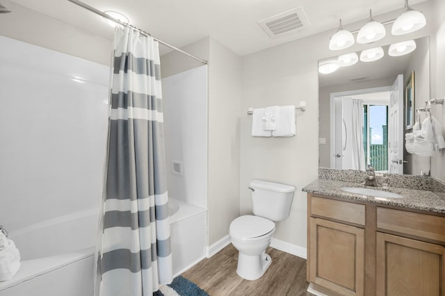 full bathroom with visible vents, toilet, shower / tub combo, vanity, and wood finished floors