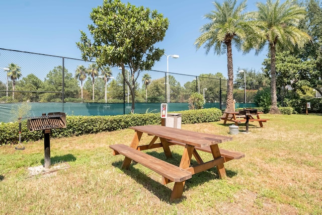 view of property's community featuring fence and a lawn