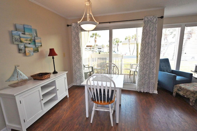 dining area featuring ornamental molding, dark wood-style flooring, and baseboards