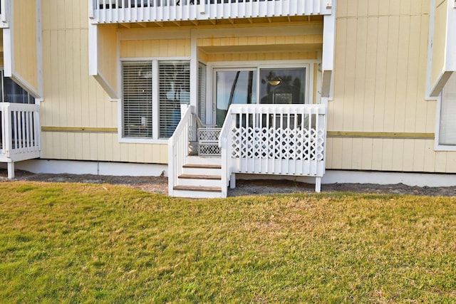 doorway to property featuring a lawn