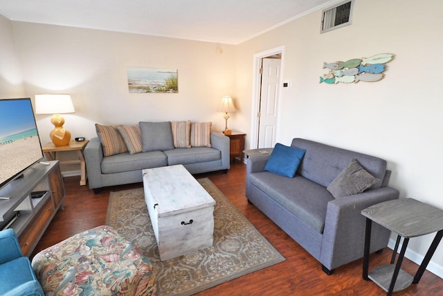 living area with dark wood-type flooring and visible vents