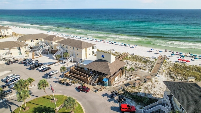 drone / aerial view with a water view and a view of the beach