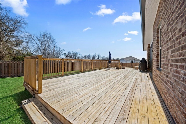 deck featuring a fenced backyard and a yard