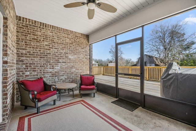 sunroom featuring ceiling fan