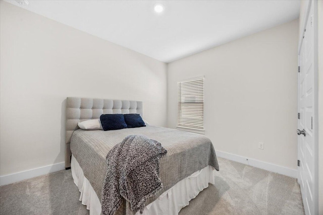 bedroom with carpet and baseboards