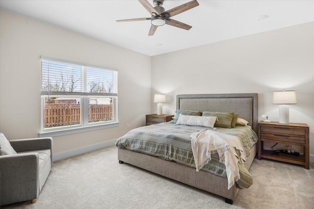 bedroom with ceiling fan, baseboards, and carpet flooring