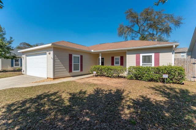 single story home with a garage, driveway, a front yard, and fence