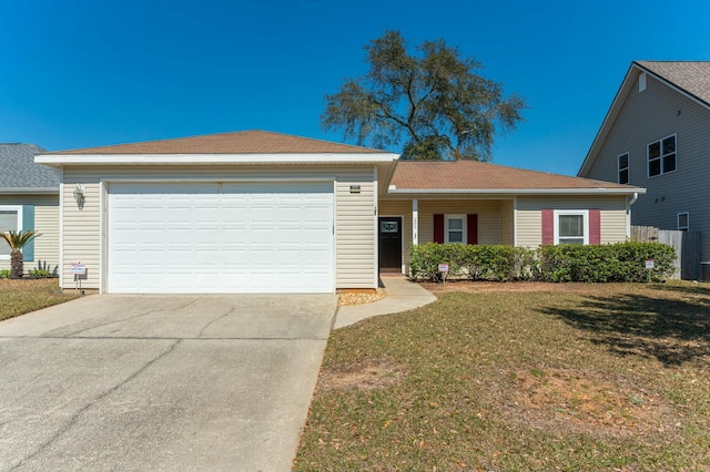 ranch-style home featuring driveway, a garage, and a front yard