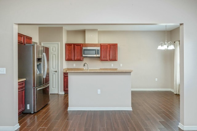 kitchen featuring appliances with stainless steel finishes, wood tiled floor, and dark brown cabinets