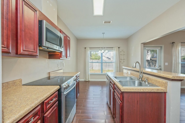 kitchen featuring dark brown cabinets, appliances with stainless steel finishes, a sink, and light countertops