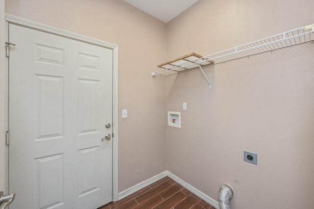 clothes washing area featuring washer hookup, wood tiled floor, electric dryer hookup, laundry area, and baseboards