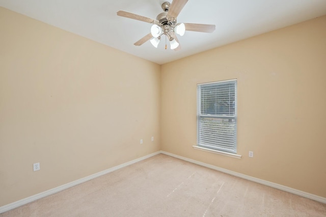 unfurnished room featuring baseboards, a ceiling fan, and light colored carpet