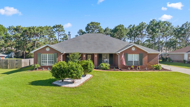 single story home with brick siding, a chimney, a front lawn, and fence