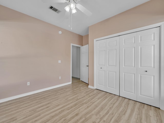 unfurnished bedroom featuring baseboards, visible vents, ceiling fan, light wood-type flooring, and a closet