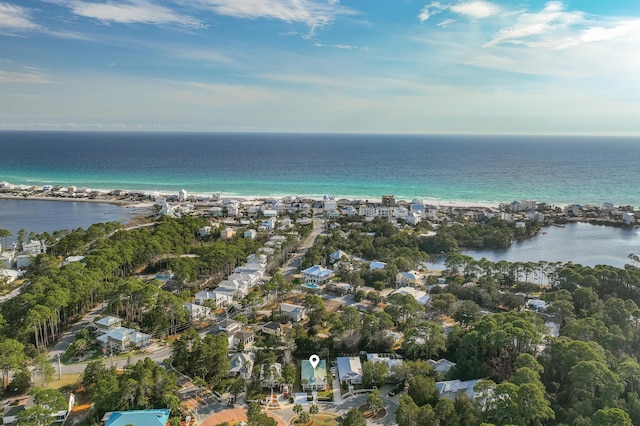 drone / aerial view featuring a water view and a beach view