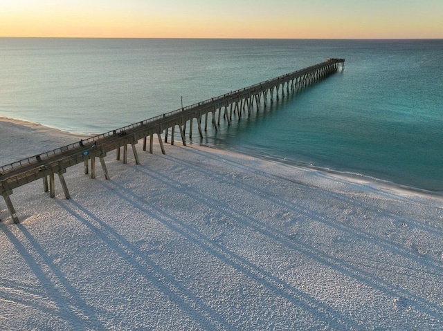 view of dock with a water view, a beach view, and a pier