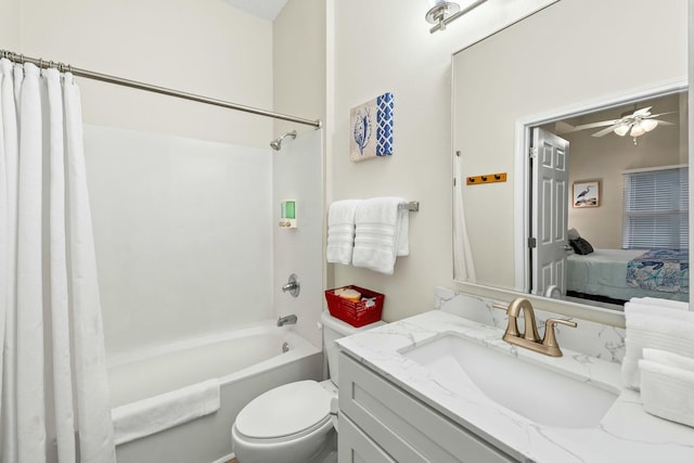 ensuite bathroom featuring shower / tub combo, a ceiling fan, toilet, ensuite bath, and vanity