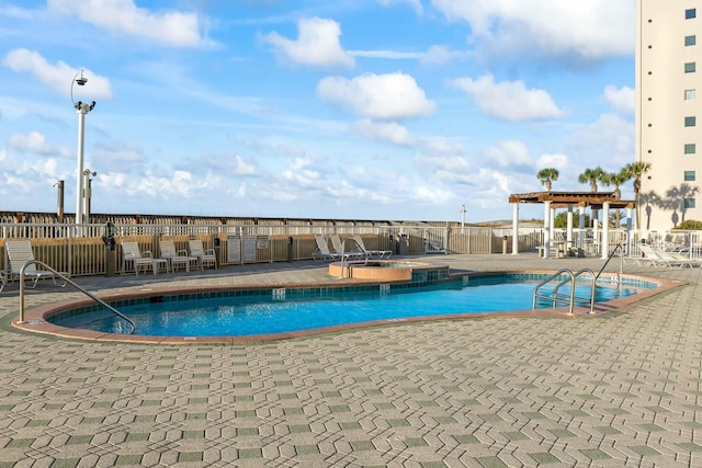 community pool featuring a pergola, a patio, and fence