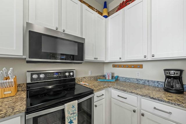 kitchen featuring stainless steel appliances, white cabinets, and light stone counters