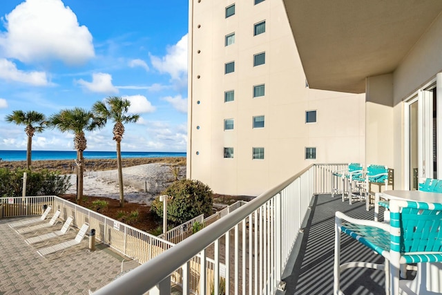 balcony with a beach view and a water view