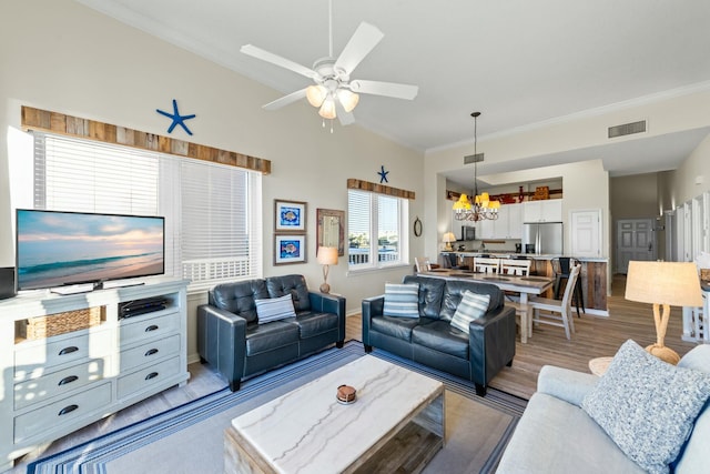 living room with ornamental molding, visible vents, and light wood-style floors