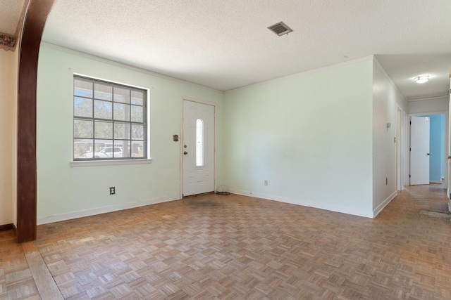 entrance foyer with baseboards, visible vents, and a textured ceiling