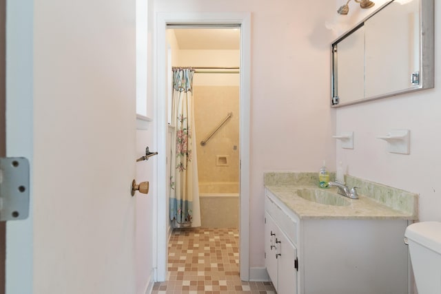 full bathroom with vanity, shower / tub combo, and toilet