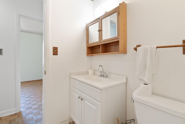 half bathroom featuring toilet and vanity