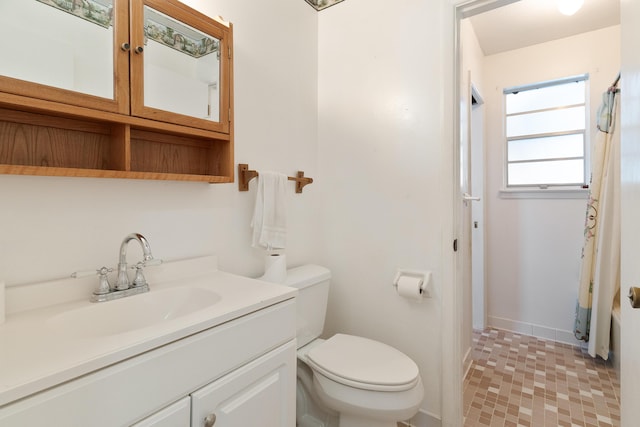 bathroom with a shower with shower curtain, toilet, and vanity