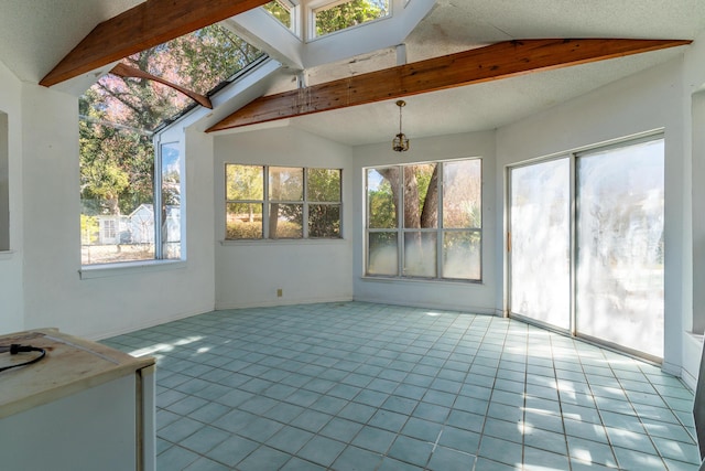 unfurnished sunroom featuring lofted ceiling with skylight