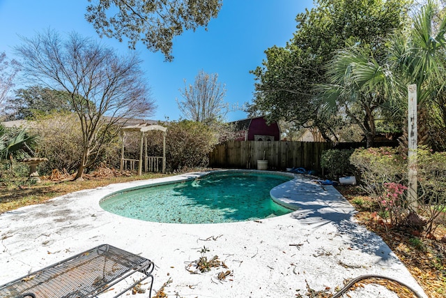 view of pool featuring a patio, fence, and a fenced in pool