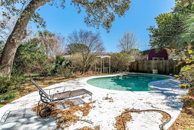 view of swimming pool with a patio area, a fenced in pool, and fence