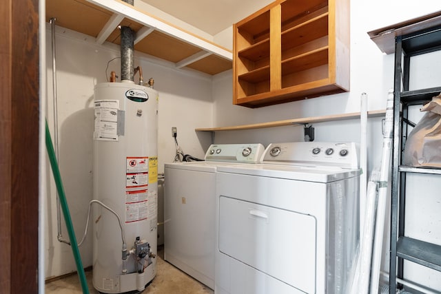 washroom with washing machine and clothes dryer, laundry area, and gas water heater