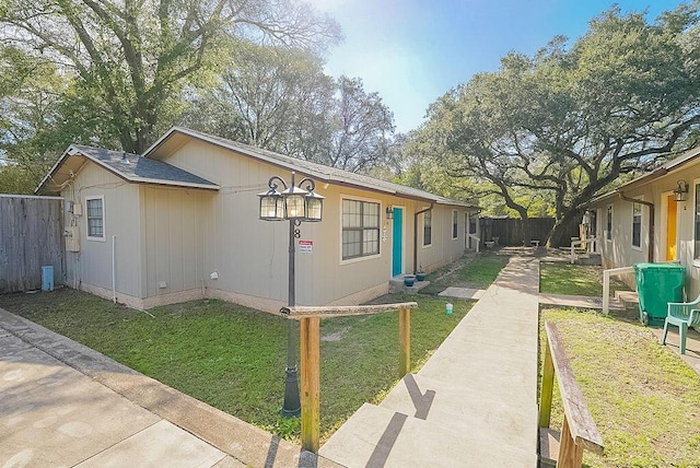 view of side of property featuring a yard and fence