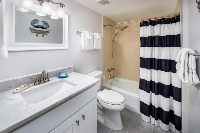 full bath with visible vents, shower / tub combo with curtain, vanity, and toilet