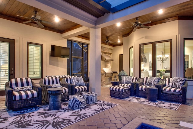 view of patio with an outdoor kitchen, an outdoor living space, and a ceiling fan