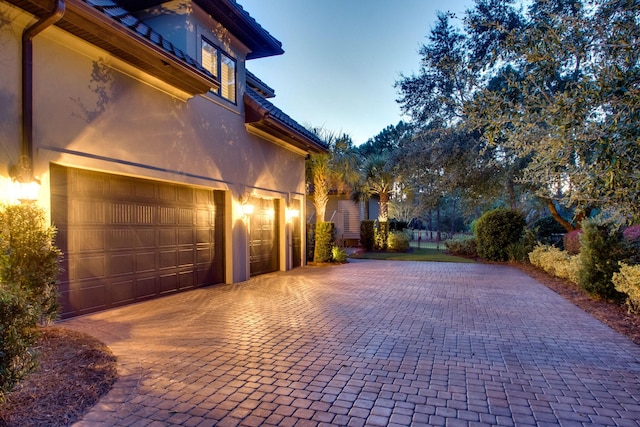 garage featuring decorative driveway