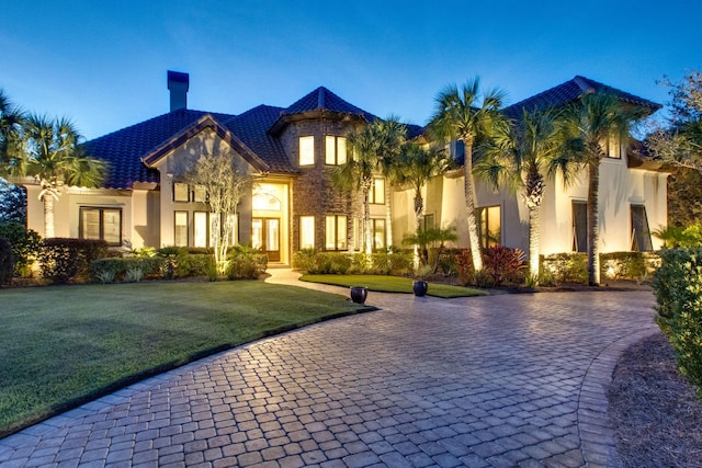 view of front of property with a front yard and stucco siding