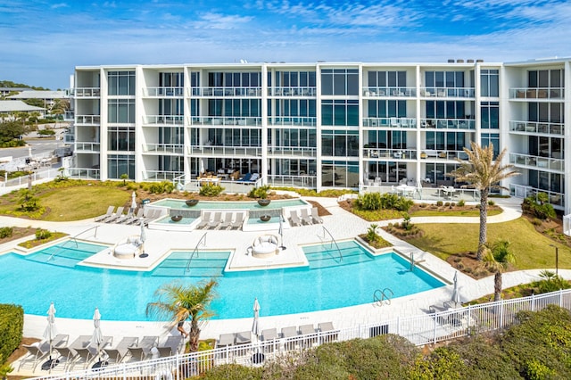 community pool featuring a patio area and fence