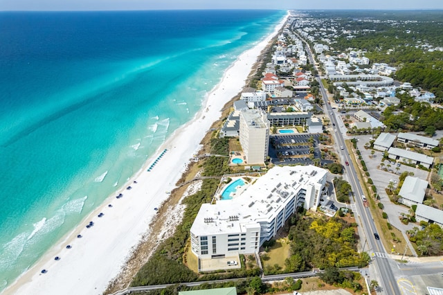 bird's eye view with a water view and a beach view