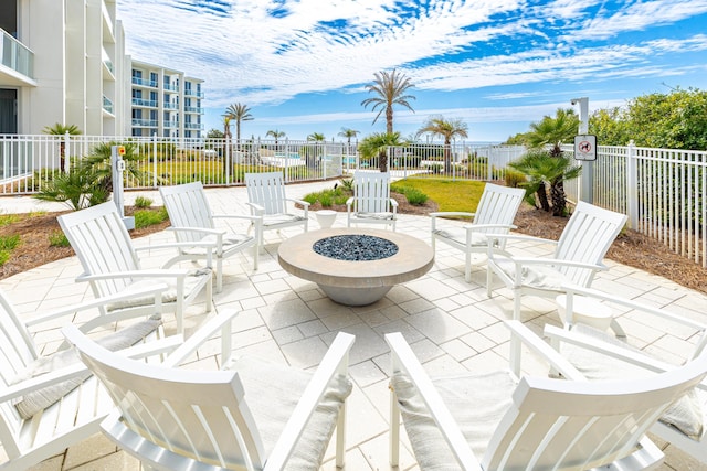 view of patio / terrace featuring an outdoor fire pit and fence