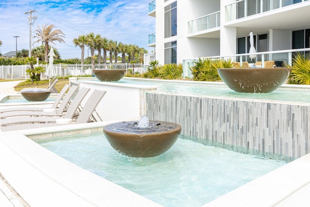 view of pool featuring fence