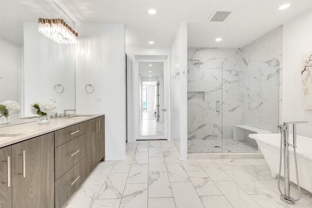 full bathroom with recessed lighting, a sink, visible vents, a freestanding bath, and a marble finish shower