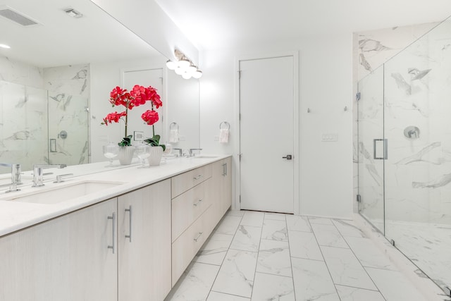 full bath featuring marble finish floor, a marble finish shower, a sink, and visible vents