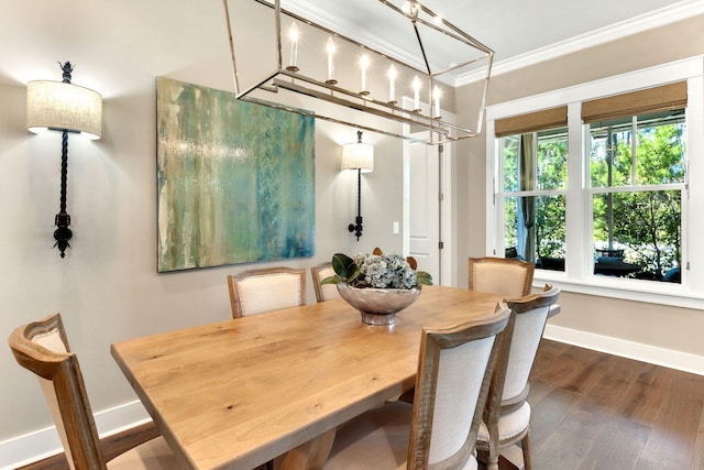 dining space with baseboards, wood finished floors, and ornamental molding